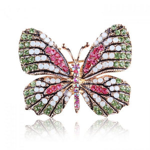 Butterfly brooch in gold with green and pink crystals 