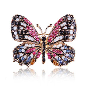 Butterfly brooch in gold with black and fuchsia crystals 