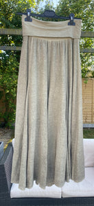 Khaki Sugarbabe maxi skirt in linen hanging on a hanger in a garden 