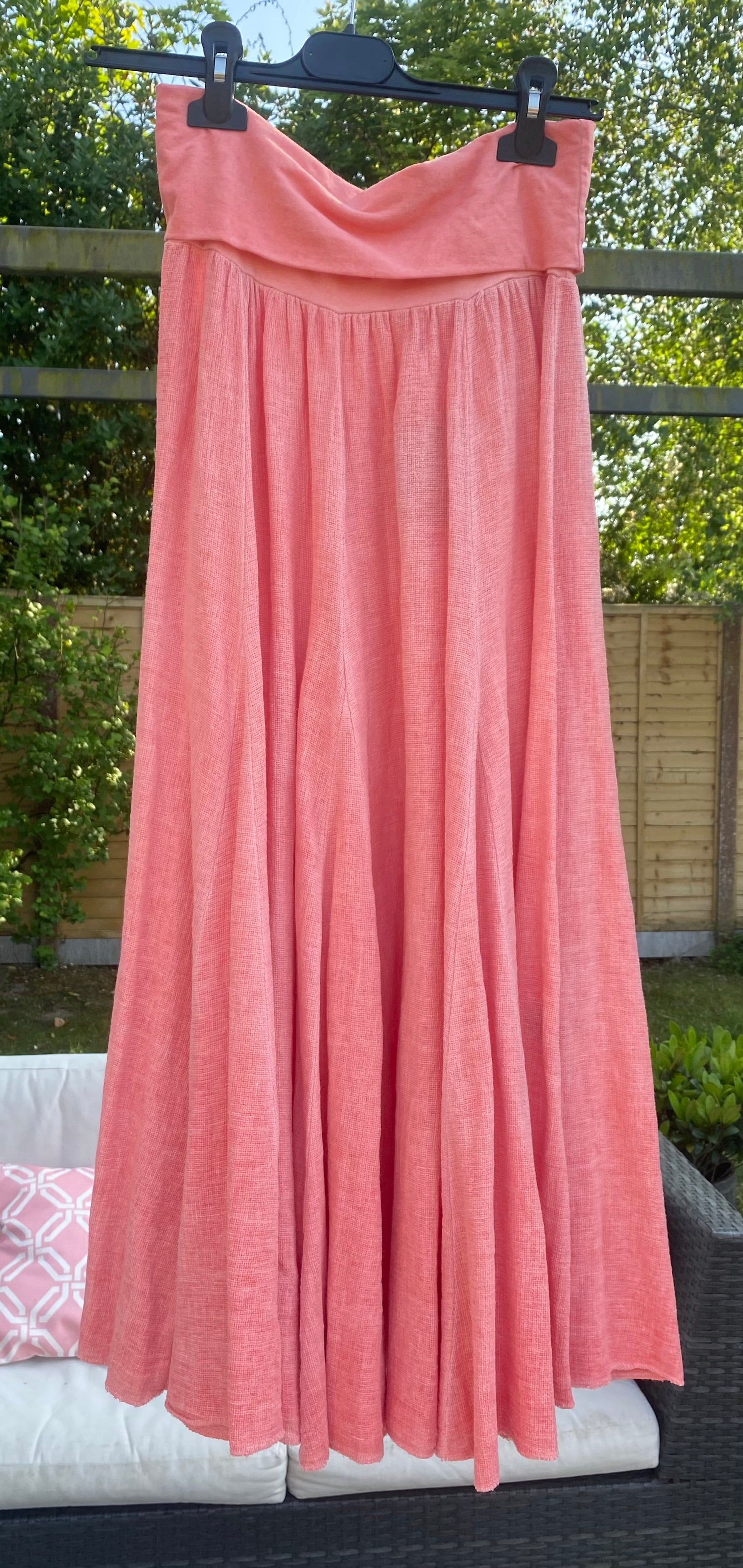 Coral linen sugarbabe maxi skirt hanging up outside 