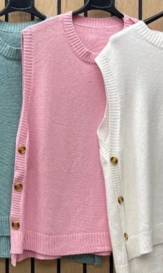 knitted vest with side buttons and round neck in baby pink on hanger