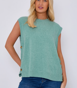 model wearing knitted vest with side buttons and round neck in cornflower blue