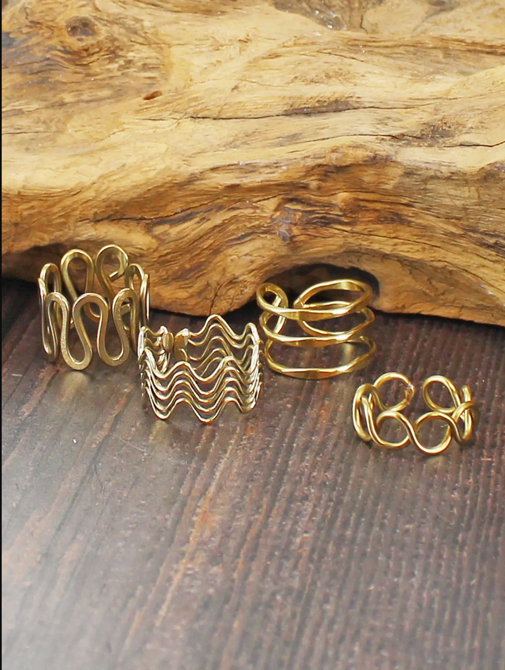 Photo of set of four gold plated brass adjustable rings in different woven multi strand detailing 