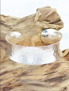 photo of solid cuff in beaten silver on bronze