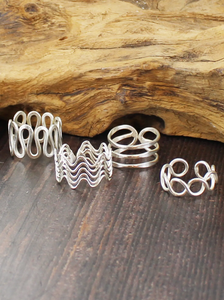 photo of silver plated set of four adjustable rings in various woven multi strand details
