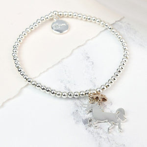 Silver beaded stretch bracelet with silver and gold unicorn charm