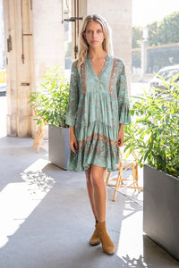 Model wearing light green and brown boho print short tunic dress