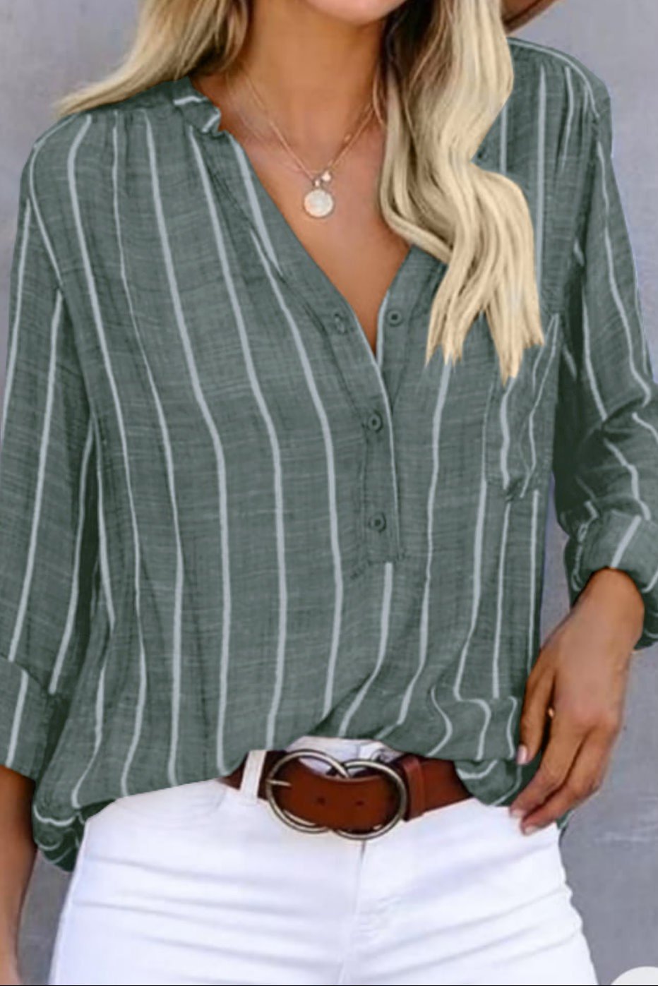 model wearing kahki green and white striped v neck button shirt and white jeans and brown belt