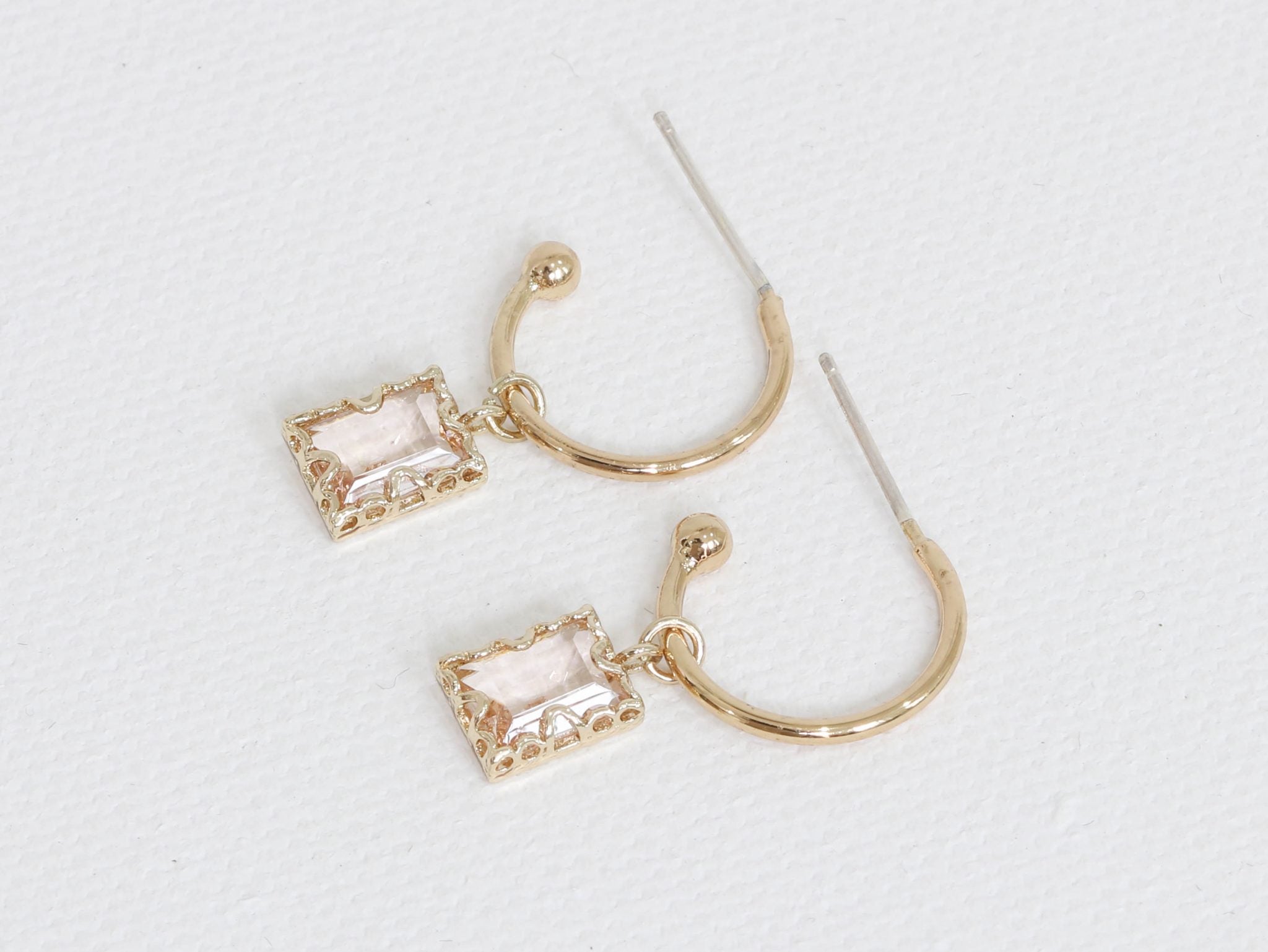Small gold hoop earrings with pink crystals