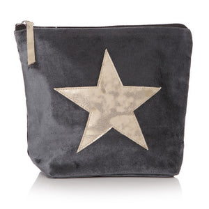 Grey velvet wash bag with gold star on front and gold pull tag