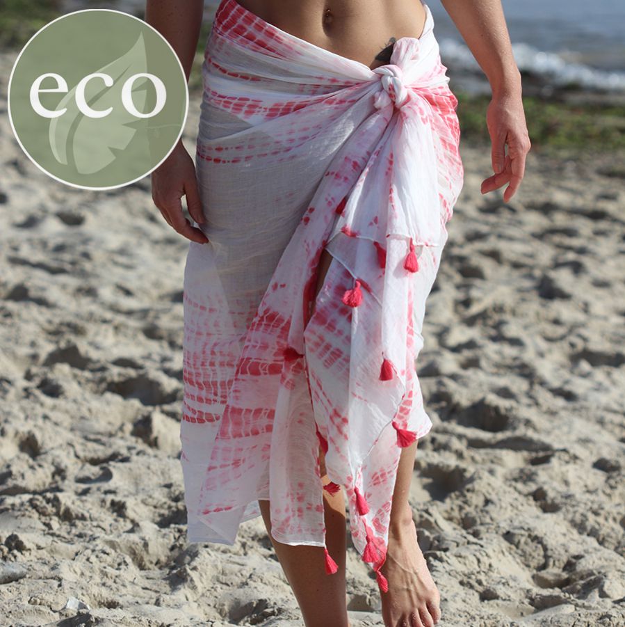 Model wearing tie dye coral and white sarong with tassels