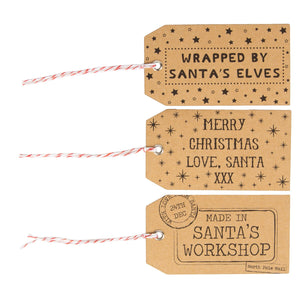 Christmas gift tags on brown card with santa and elves and workshop messages