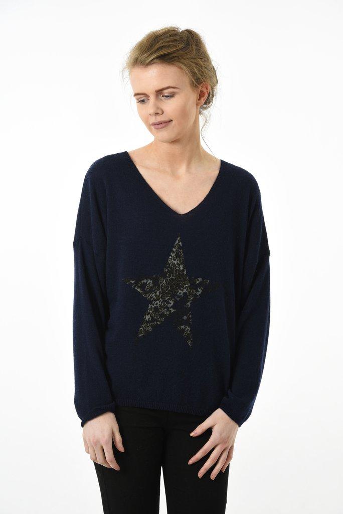 Model wearing navy long sleeve jumper with leopard print star on front