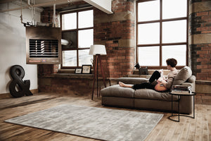 Loft room design with light grey modern rug