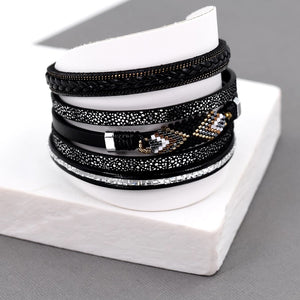 Multi strand bracelet with crystals and beads in aztec design on middle strand