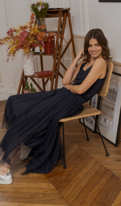 Model sitting down wearing tulle maxi skirt in navy 