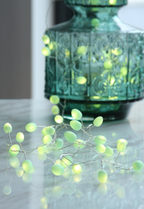 Mint battery teardrop fairy lights draped out of green vase