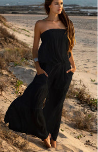 model wearing bardot style long wide leg summer cotton jumpsuit with tie waist in midnight
