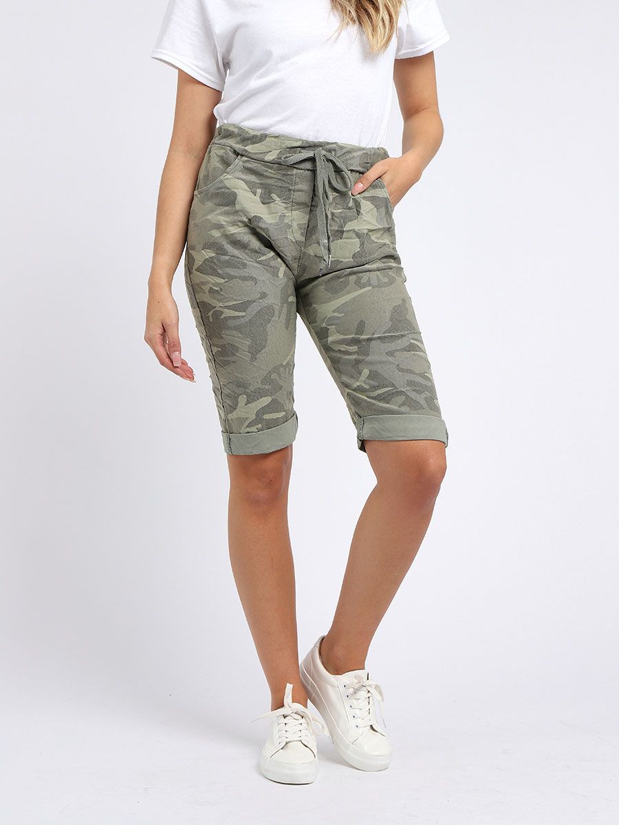 Model wearing kahki camo stretch shorts with drawstring waist, white t shirt and white trainers